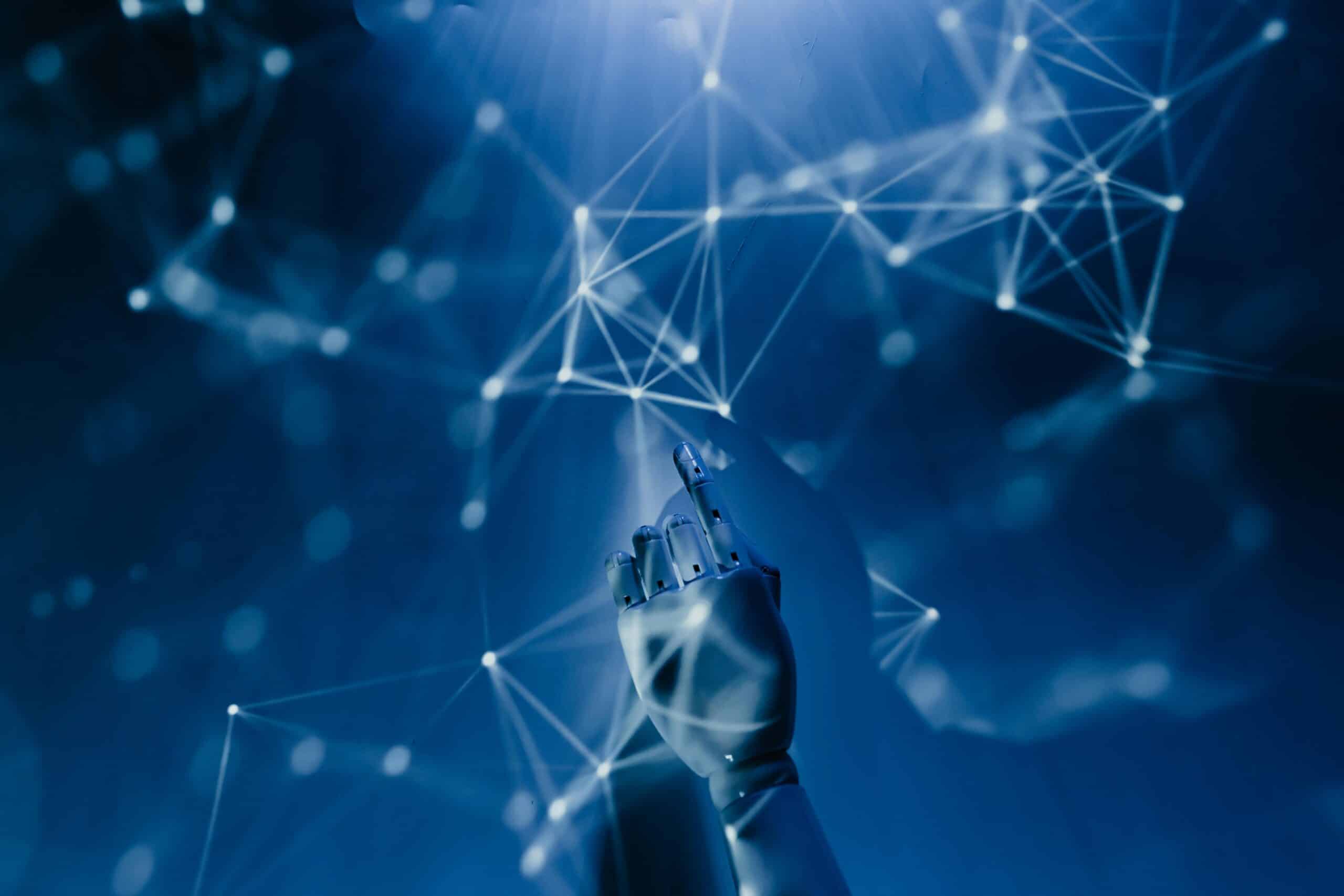 AI-Demystified_-What-to-Know-About-the-Current-Tools-on-the-Market-in-2025-scaled.jpg Free A robotic hand reaching into a digital network on a blue background, symbolizing AI technology. Stock Photo
