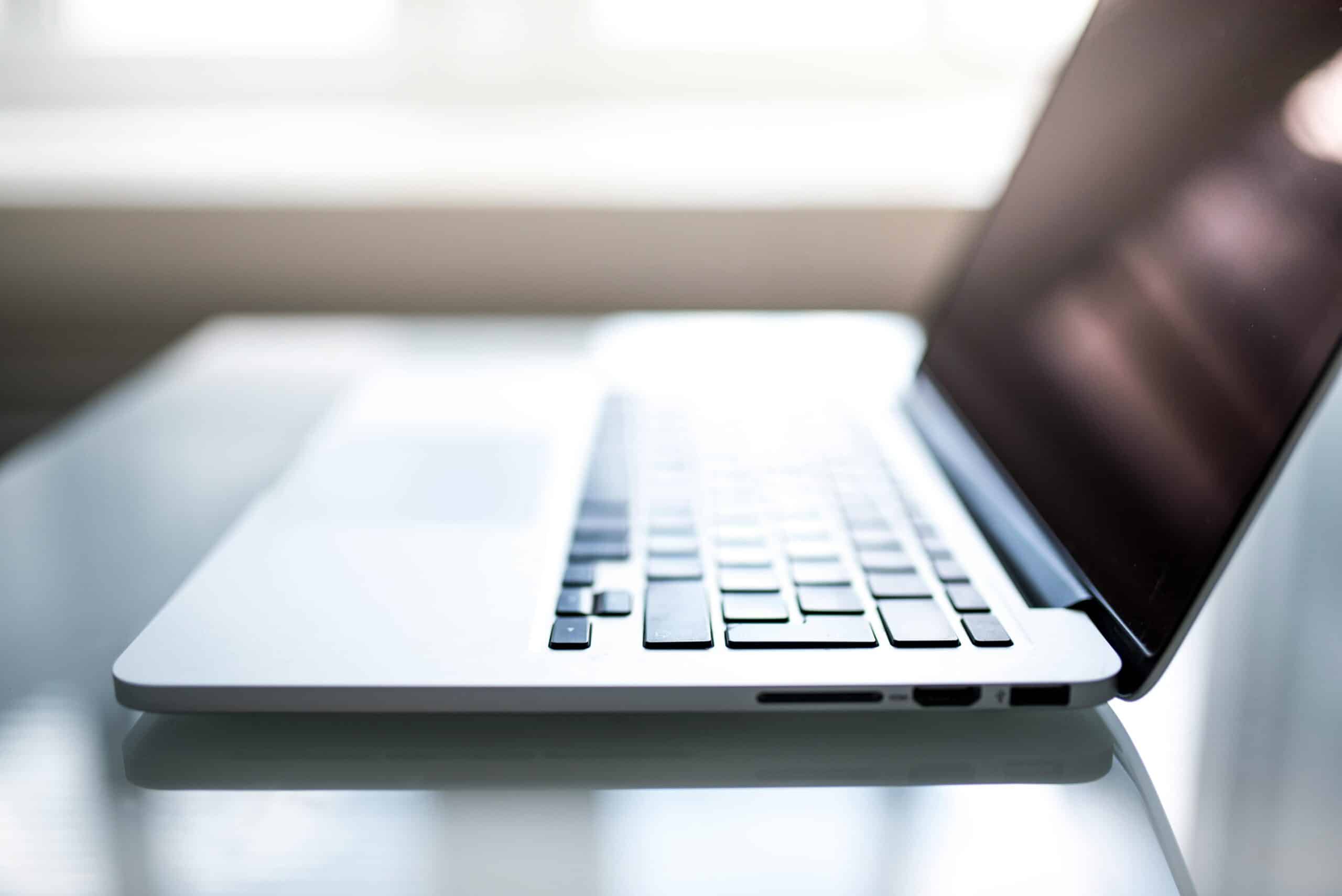 What-Your-Small-Business-MUST-Know-About-Data-Regulations-in-2025-scaled.jpg Free Elegant side view of a laptop on a glossy table with natural lighting indoors. Stock Photo